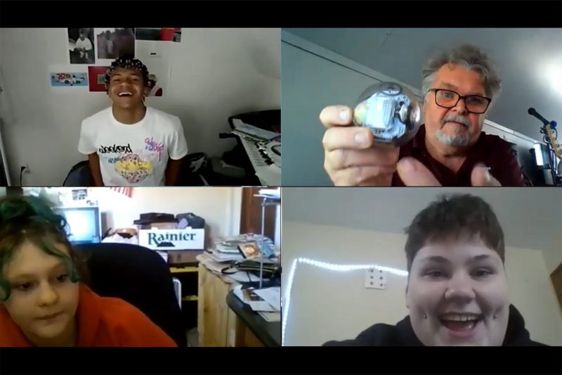 A screenshot taken during Zoom, a gallery of four faces.